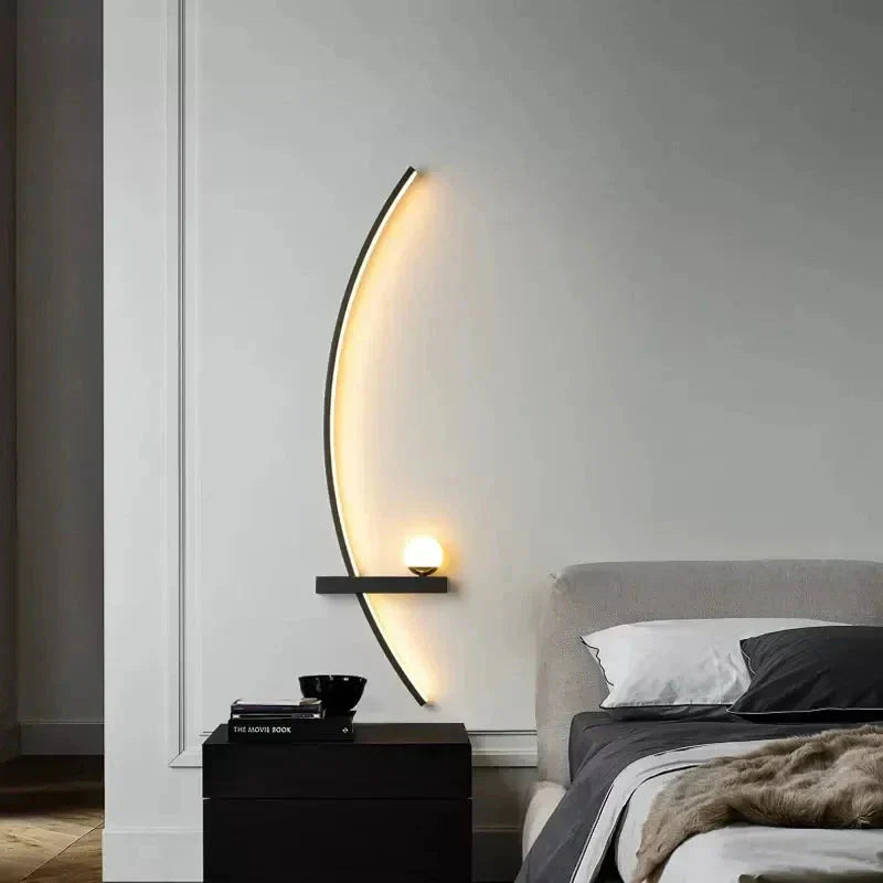 Modern bedroom with a curved wall light fixture and bed.